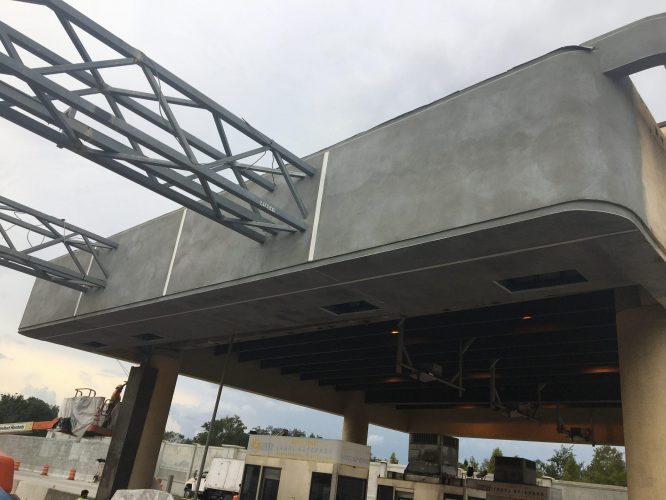 Orlando General Contractor finishing stucco of toll booth canopy